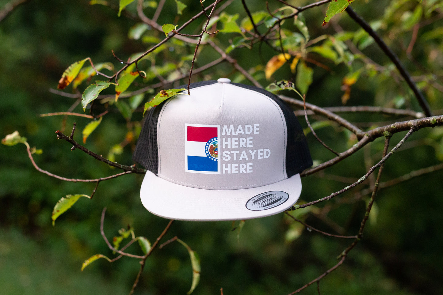"MADE HERE, STAYED HERE" FLATBILL SNAPBACK TRUCKER HAT