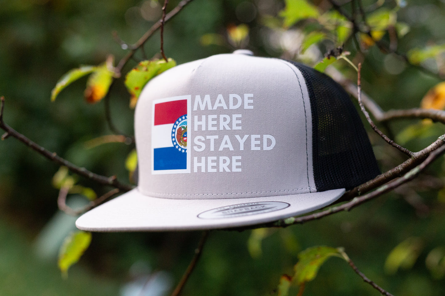 "MADE HERE, STAYED HERE" FLATBILL SNAPBACK TRUCKER HAT